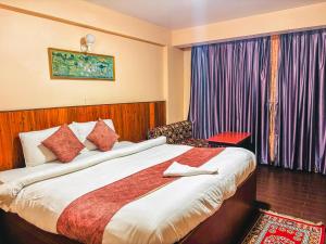 a hotel room with a bed and a window at Rare Himalayas Mansarovar in Darjeeling