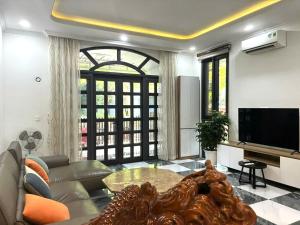 a living room with a couch and a tv at Canisa Villas in Phú Quốc