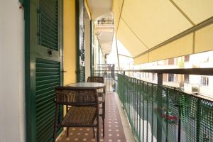 a balcony with a table and chairs on a building at Alassio bnb Apartments in Alassio