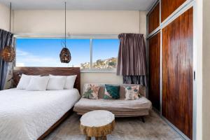 a bedroom with a bed and a couch and a window at Romantic Zone in Puerto Vallarta