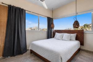 a bedroom with a bed and a large window at Romantic Zone in Puerto Vallarta