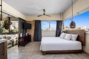 a bedroom with a bed and a large window at Romantic Zone in Puerto Vallarta