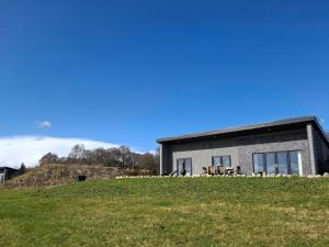 a house on top of a grassy hill at Red Squirrel in Dornoch