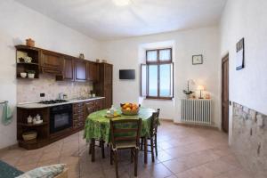 a kitchen with a table with chairs and a tableablish at I Castagnini in Montecatini Val di Cecina