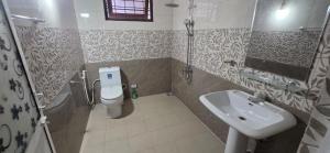 a bathroom with a toilet and a sink at Silver Spring Villa in Siyambalape