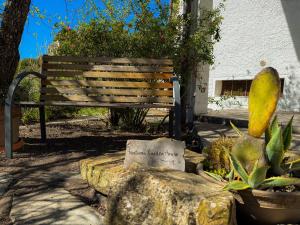 a park bench in a garden with a plant at Fortuna Garden House in Imperia