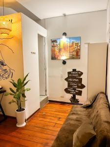 a room with a bed and signs on the wall at Hostel Prada in Lima