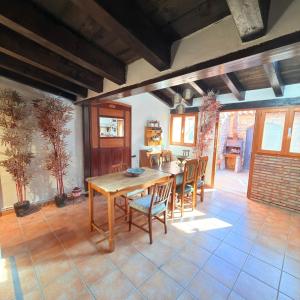 a dining room with a wooden table and chairs at Cielos in Celadas