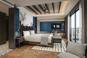 a bedroom with a bed and a clock on the wall at Glond Hotel in Luang Prabang +64 photos