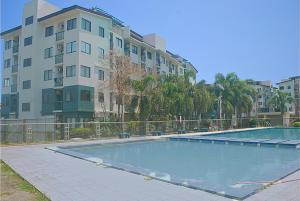 an empty swimming pool in front of a building at Charm Condo Just Steps from Enchanted Kingdom Sargas in Santa Rosa