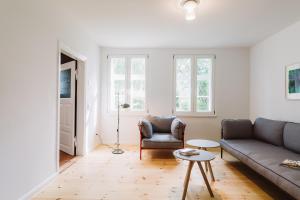 a living room with a couch and a chair at Kapitänshaus Wieck in Wieck