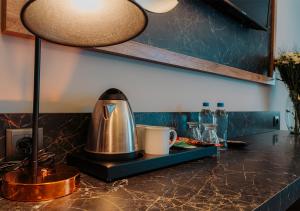 a kitchen counter with a coffee pot on a tray at City Port Hotel Trabzon in Trabzon