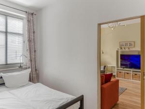 a bedroom with a mirror and a bed and a television at Objekt-Nr 247 - Hafen - Kurgartenstraße in Travemünde
