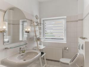 a white bathroom with a sink and a toilet at Objekt-Nr 247 - Hafen - Kurgartenstraße in Travemünde