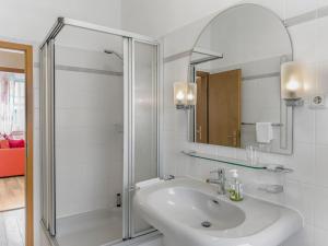 a white bathroom with a shower and a sink at Objekt-Nr 247 - Hafen - Kurgartenstraße in Travemünde +3 photos