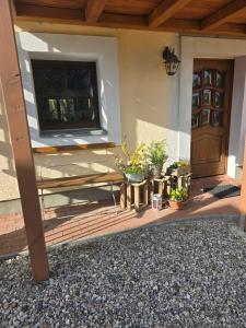 a porch of a house with a tv and plants at Auszeit Posthausen in Machern