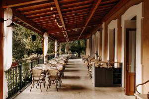 a row of tables and chairs on a balcony at Logis - Hotel Restaurant du Parc in Cransac