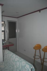 a living room with a couch and two stools at Charm Condo Just Steps from Enchanted Kingdom Sargas in Santa Rosa +17 photos