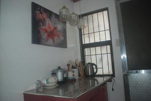 a kitchen with a counter top and a window at Charm Condo Just Steps from Enchanted Kingdom Sargas in Santa Rosa