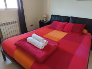 a bed with two towels sitting on top of it at Casa Flamenca en El Ventorrillo - Piscina, Tumbonas, Terraza y Aparcamiento in Cúllar-Vega