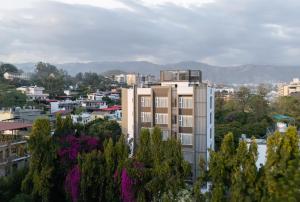 a view of a city with buildings and trees at Hotel HiStays, Dehradun in Dehradun