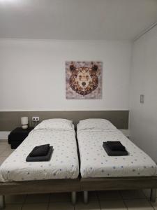 two beds sitting next to each other in a room at Studio 110 pres Basel Airport in Saint-Louis