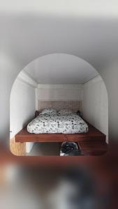 a small bedroom with a bed in a room at Ti case ali in Saint-Benoît