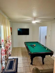a living room with a pool table and a tv at Island 1 in Kissimmee