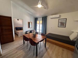 a room with a table and a bed and a bedroom at Résidence Punta paliagi in Calcatoggio +28 photos