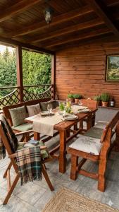 a patio with a table and chairs on a deck at Villa Felicity in Nová Lesná