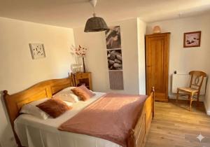 a bedroom with a bed and a chair in it at Ombre Bleue Du Figuier, Ailhon in Ailhon +61 photos
