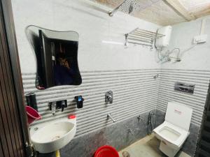 a person taking a picture of a bathroom with a sink at Dwarkapuri Paras guest house in Mathura