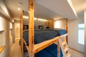a bedroom with a bunk bed in a loft at SUNZ ROOMS -naha miebashi- in Naha