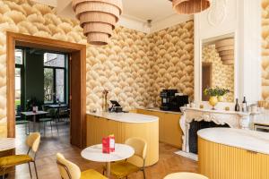 a restaurant with tables and chairs and a fireplace at Luxury B&B The Belgian Girl in Ghent