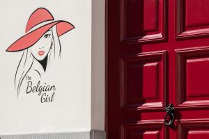 a door with a painting of a woman wearing a red hat at Luxury B&B The Belgian Girl in Ghent