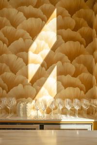 a row of wine glasses on a table with a wallpaper at Luxury B&B The Belgian Girl in Ghent +47 photos