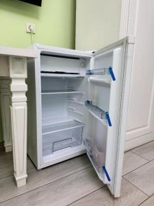 an empty refrigerator with its door open in a room at Diamond Hotel Даймонд Отель in Var-Kyshtak