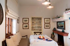 a dining room with a table with a plate of fruit on it at Sappho House in Skala Eresou