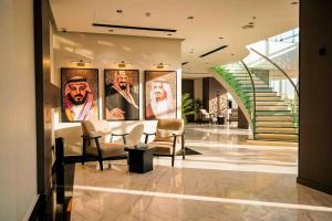 a lobby with four paintings on the wall at فندق جديل2 - Jadeel Hotel 2 in Al Khobar
