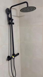 a shower with a shower head in a bathroom at Thelma house Tossa in Tossa de Mar +10 photos