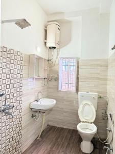 a bathroom with a toilet and a sink at Hotel Arawali Hill in Udaipur +18 photos