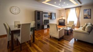 a living room with a dining room table and chairs at Feel Belgrade Apartments in Belgrade