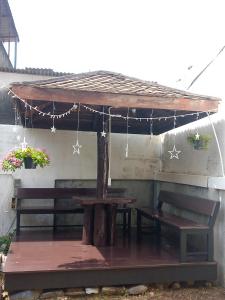a gazebo with a picnic table and benches at Anchan Home Stay Hatyai in Hat Yai