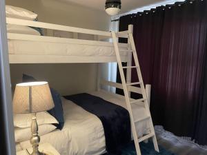 a bedroom with two bunk beds and a lamp at Stylish stay at Hartensee in Mossel Bay
