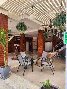 a patio with a table and chairs in a building at Changsova Hotel in Ban Chang