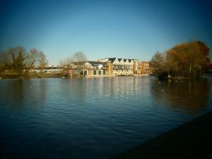 a large body of water with a building in the background at Central Windsor House in Windsor