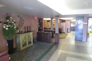 a lobby with a store with flowers on the wall at Rocky Inn Express in Rocky Mountain House