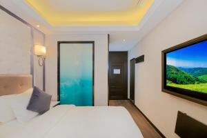 a bedroom with a bed and a large window at WangfujingXiyuanHotel Central Beijing in Beijing