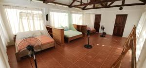 a room with two beds and a fan in it at The Amazing Villa in Anepahan