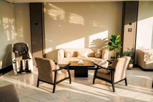 a living room with a couch and a table and chairs at فندق جديل2 - Jadeel Hotel 2 in Al Khobar